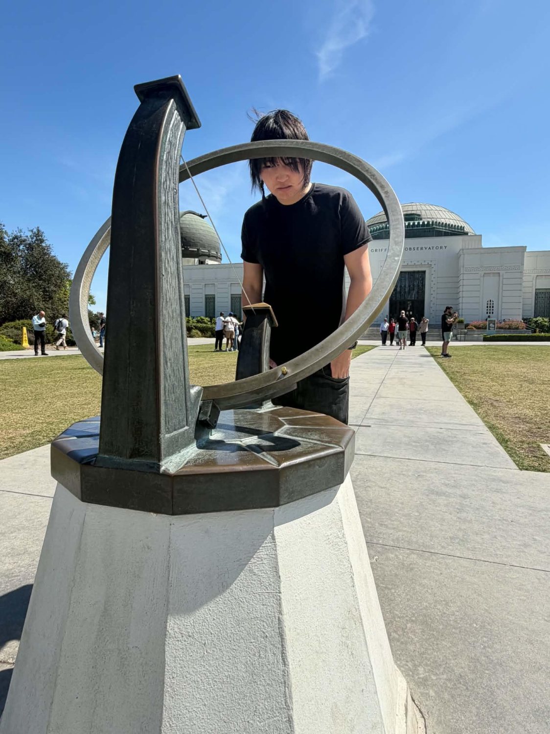 Anand beside the telescope monument at Griffith Observatory